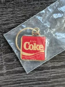 VINTAGE ENJOY COKE COCA~COLA RED GOLD TONE KEYCHAIN 1.25" x 1.25" - SEALED RARE - Picture 1 of 4