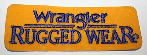 2 Vintage Filz Bügelbild Wrangler robuste Kleidung Stoff Angeln Turnier Patch Neu aus altem Lagerbestand - Bild 1 von 1