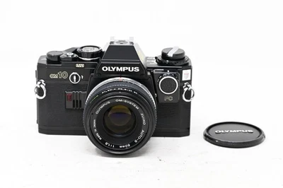 Olympus OM-10 fotocamera manuale + obiettivo 50 mm f/1.8 OM + adattatore manuale Olympus (#B60) - Immagine 1 di 4