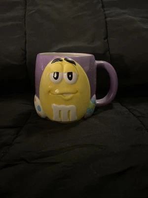 M&M Collectible Coffee Mug Decorated with a Yellow M&M and Easter Eggs - 2001 - Image 1 of 3