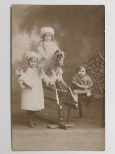Three Children Rocking Horse Doll Studio Portrait c1910s VTG Real Photo Postcard - Picture 1 of 2