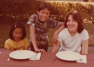 1970s Girl Boy Woman Smiling Portrait Picnic Table Backyard Friends - Picture 1 of 3