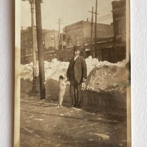 Antique Sepia Snapshot Photograph Man On Street With Dog Doing Trick Snow Odd - Picture 1 of 9