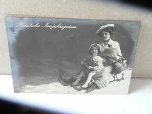 AK Herz.Neujahrsgrüsse Frau,Mädchen,Schlitten,Geldsäcke,Schnee gel.26.XII.16 - Bild 1 von 3