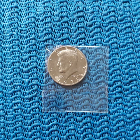 #15 . 1972d  kennedy  half dollar  Uncirculated i opened package.  pictured Cover