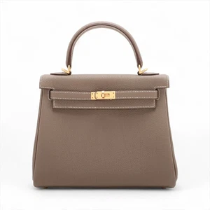 Hermès Kelly 25 Le Tournay Togo Etoupe oro mate herrajes K: 2025 - Imagen 1 de 12