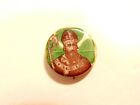 older celluloid pin with St. Patrick&#39;s portrait over a shamrock