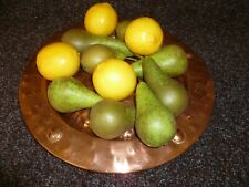 AN ANTIQUE HAND HAMMERED COPPER FRUIT BOWL. A HAND HAMMERED COPPER PLATE