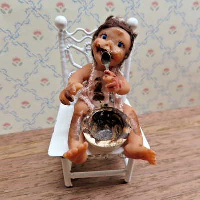 Casa de Muñecas Miniaturas Hechas por Artista Niña en Mameluco Rosa y Cubiertas de Chocolate Foto 1 de 4