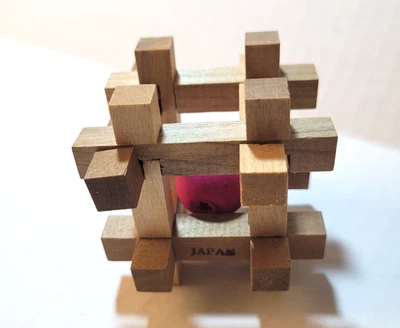 KUMIKI WOOD INTERLOCKING PUZZLE - CAPTIVE RED BALL - 2 1/2" -JAPAN -W/DIRECTIONS - Image 1 of 4