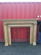 A RECLAIMED LARGE DECORATIVE CARVED PINE FIRE SURROUND -