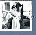 FOUND B&W PHOTO T_0943 WOMAN IN DRESS HOLDING BABY BY HOUSE