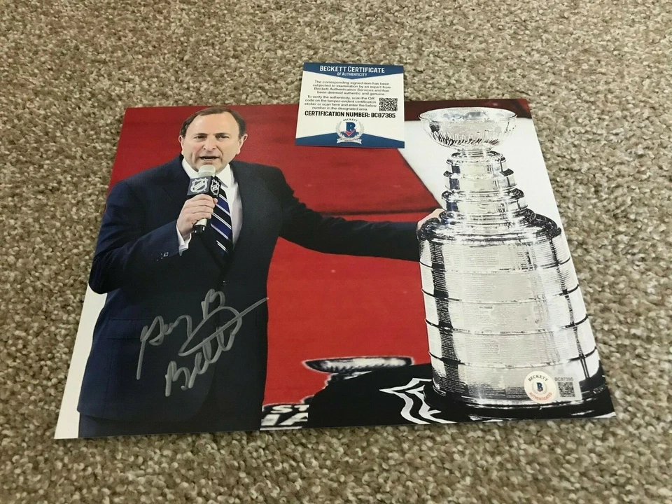 GARY BETTMAN Signed Autograph 8x10 Photo NHL COMMISSIONER  WITH CUP BAS BECKETT - Image 1 of 1