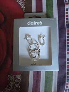Nuevo juego de 4 anillos/pendientes de plata de Claire's - Imagen 1 de 4