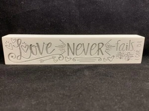 Love Never Fails White Plaque 1 Corinthians 13:8 Message Cast Stone 7.25" x 1.5" - Picture 1 of 8