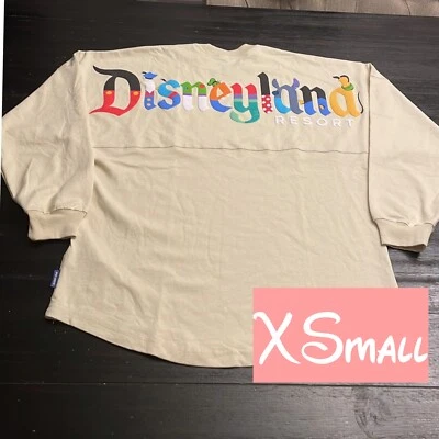 Camiseta deportiva Disney Parks Disneyland Personaje Letras Beige Espíritu NUEVA CON ETIQUETAS XSMALL Foto 1 de 4