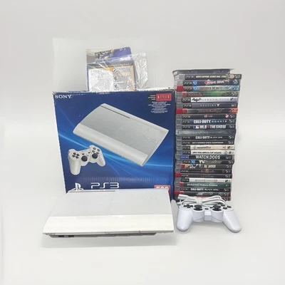 HUGE PS3 Super Slim White Bundle! 27 Games, 2 Controllers, Manual, & Cables - Image 1 of 4