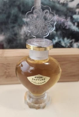 Rapture cologne by Avon. Glass Bottle with Heart stopper. 4"   0.5 fl oz FULL - Image 1 of 4