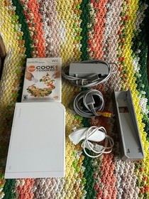 Wii bundle with console, game, and power cords, tested and working