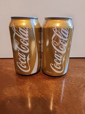 2 latas de oro Coca Cola Vancouver 2010 Juegos Olímpicos sin abrir y vacías Foto 1 de 4