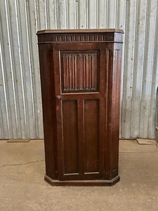 An oak hall cupboard with carved linen fold panel - Picture 1 of 6