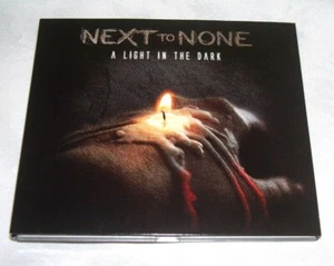 NEXT TO NONE - A LIGHT IN THE DARK - LIMITED EDITION DIGIPAK - 9 TRACK CD ALBUM - Picture 1 of 3