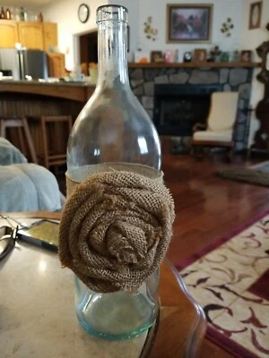 Botella de vino de vidrio transparente con arpillera y flor de encaje decoración del hogar Foto 1 de 4