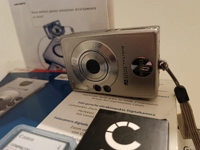 Completa E Perfettamente Funziononante Canon Digital Ixus V2.Batteria Nuova Plus - Immagine 1 di 4