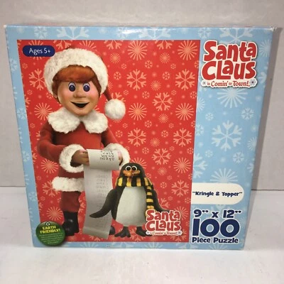 PUZZLE DE 100 PIEZAS, SIN ABRIR SANTA CLAUS IS COMING TOWN PUZZLE KRINGLE & TOPPER Foto 1 de 4