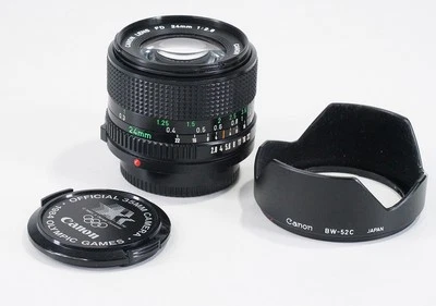 24MM 24/2.8 CANON FD-N (POLVO, ESCOMBROS) + SOMBRA + TAPA OLÍMPICA/221319 Foto 1 de 2