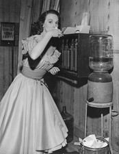 Lucille Bremer takes a drink of water on the set of the film 'Y - 1945 Old Photo