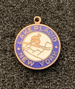 Vintage Lake Placid New York Skiing Skating Brass Tone Metal Round Pendant - Picture 1 of 3
