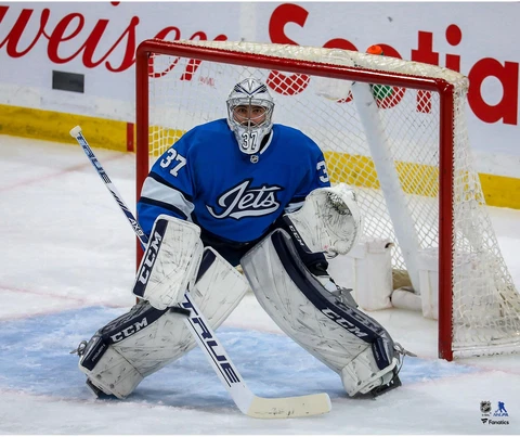 Connor Hellebuyck Winnipeg Jets Unsigned Alternate Jersey in Net Photo Cover