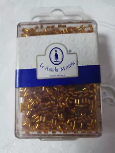 Lot 35 grammes de perles petit tube doré foncé n°104 mercerie broderie Lunéville - Foto 1 di 3