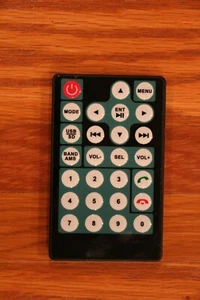 SMALL BLACK GREEN 27 BUTTON FLAT CAR STEREO REMOTE BATTERIES INCLUDED - Picture 1 of 2