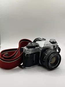 Canon AE-1 Program fotocamera reflex pellicola nero e argento 35 mm manuale esposizione automatica - Foto 1 di 17