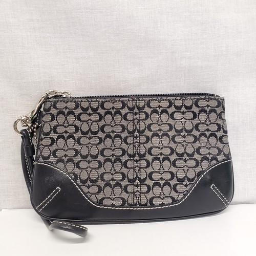 Portafoglio Coach nero e grigio in tessuto e pelle con ciondolo borsa