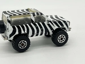 Matchbox Ford Bronco ll 1987 - WHITE/ PURPLE ZEBRA STRIPES - Rare 1:57 Loose - Picture 1 of 9