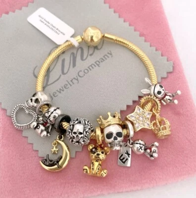 Brazalete de cadena de serpiente de oro amarillo Linx con dijes temáticos de calavera Foto 1 de 4