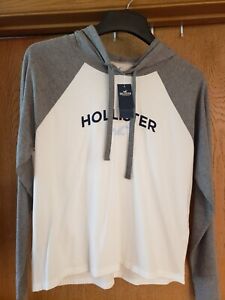 NWT HOLLISTER WOMEN’S WHITE MED LONG SLEEVE HOODED SHIRT..BRAND NEW WITH TAGS..