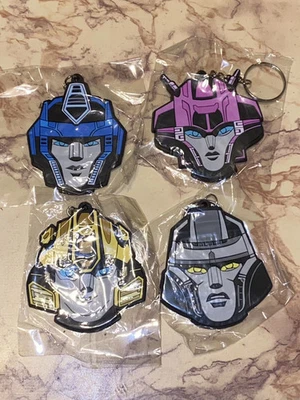 TRANSFORMERS ONE FAN EVENT KEYCHAINS SET-OPTIMUS PRIME ELITA BUMBLEBEE MEGATRON - Image 1 of 2