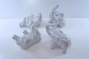 JUEGO DE CUATRO FIGURAS DE ELEFANTE GRIS PERLA IRIDISCENTES ¡TRONCADAS TAN ORDENADAS! - Imagen 1 de 1
