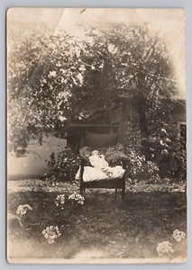 RPPC Baby Propped For Photo In Chair Outside In Garden Postcard - Picture 1 of 2