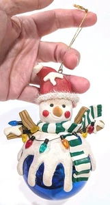 Faux Clay Melting Snowman Ornament Holding Lights On Plastic Blue Ball  - Picture 1 of 6