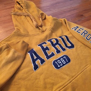 Sudadera con Capucha Y2K Aeropostale Grande Amarilla Pullover Aero 1987 Gráfico Logo Sudadera  - Imagen 1 de 7