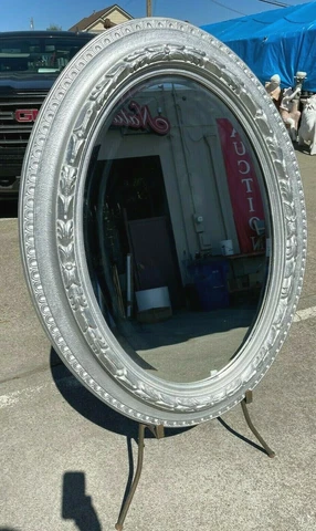 Oval Beveled Glass Mirror Framed in Carved Silvered Wood Frame Cover