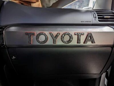 TOYOTA 4Runner Passenger Dash Trim Garnish Heritage Raised Red Two-Toned Letters - Image 1 of 4