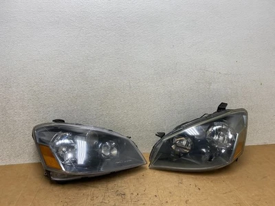 Juego de faros halógenos izquierda+derecha Nissan Altima 2005 a 2006 OEM T3720 DW Foto 1 de 4