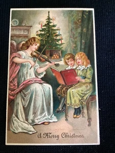 Embossed Victorian Christmas postcard angel playing violin children tree - Imagen 1 de 2