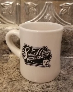 Taza STOUTHAUS COFFEE PUB años 50 estilo comedor blanco roto negro logotipo hombre 11 oz EE. UU. - Imagen 1 de 5